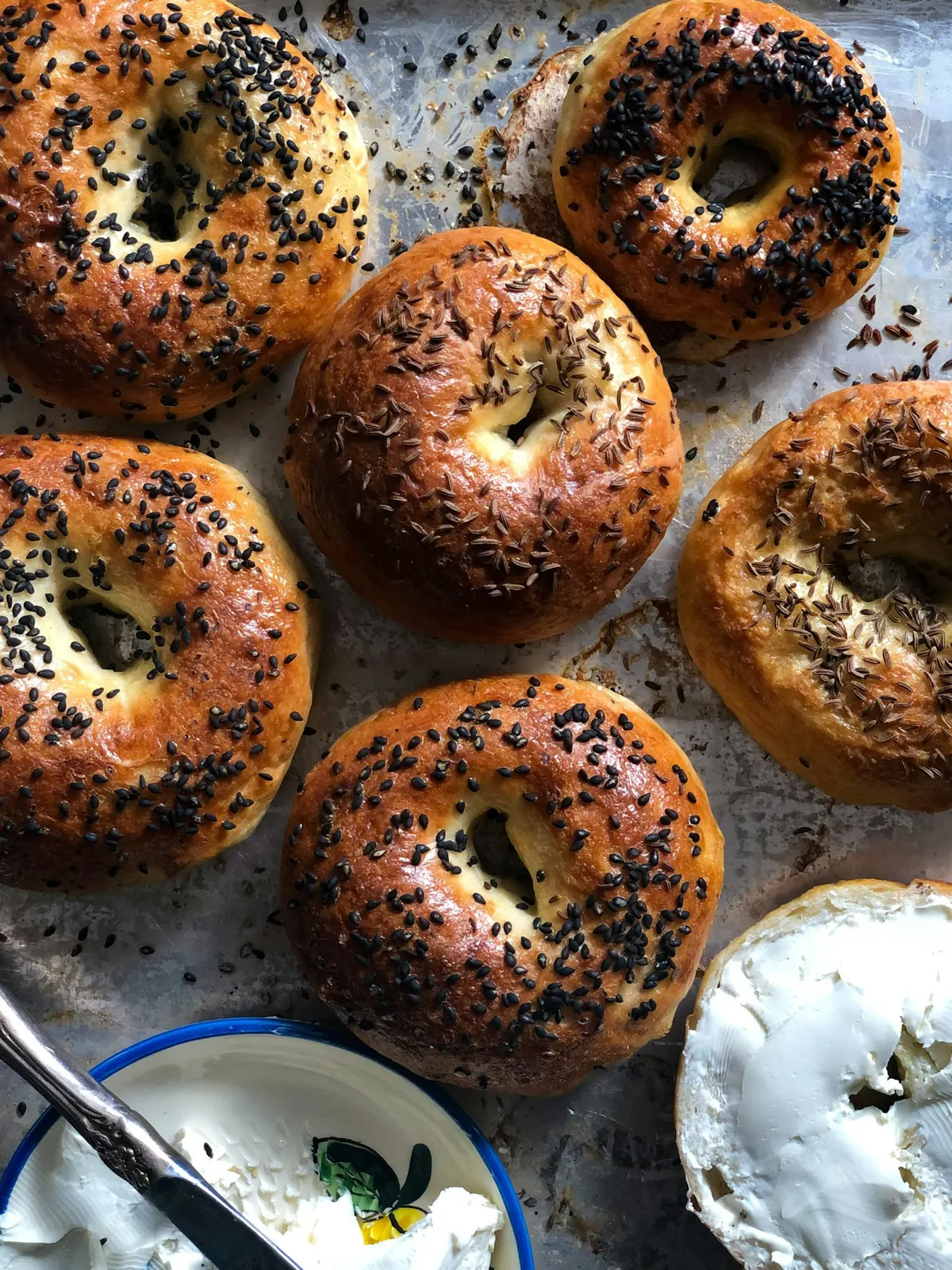 Sesame and everything bagels with cream cheese