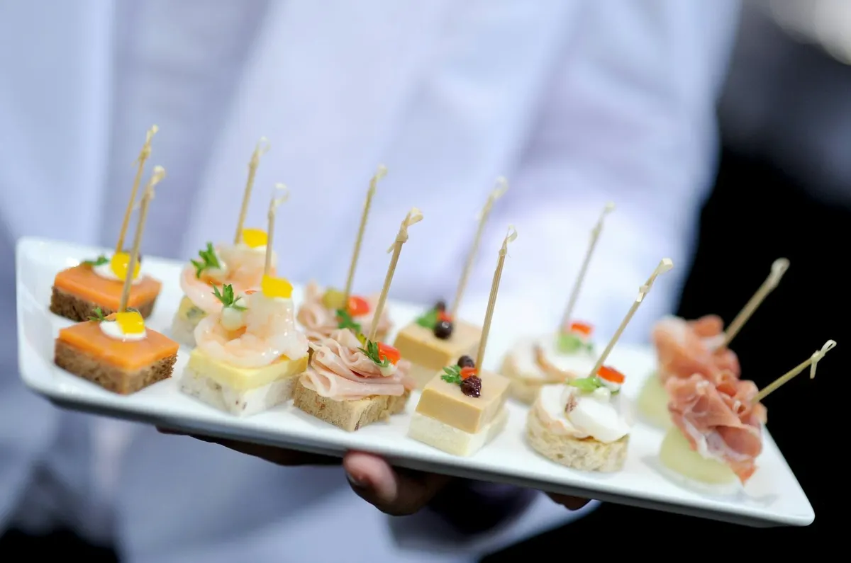 Server holding a tray of Epic hors d'oeuvres