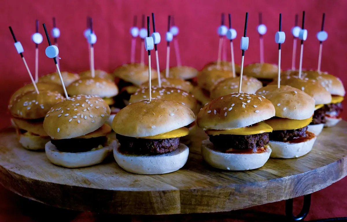 Platter of mini burger sliders on skewers